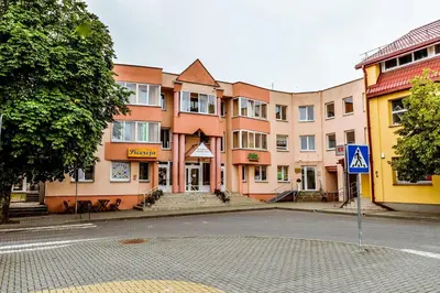 an empty street in front of a building at Guest House Simona in Lazdijai