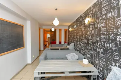 a room with a chalkboard wall with a bed at Guest House Simona in Lazdijai
