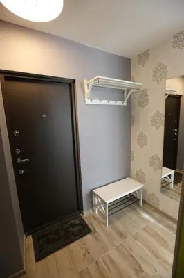 a room with a door and a table and a bench at Modern & Homely Apartment - FREE PARKING - NETFLIX in Kaunas