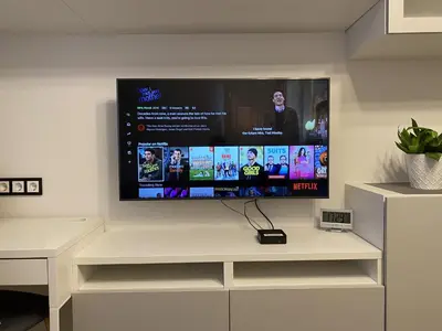 a flat screen tv on a wall in a living room at Modern & Homely Apartment - FREE PARKING - NETFLIX in Kaunas