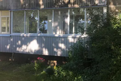 a white house with windows and plants in front of it at Modern & Homely Apartment - FREE PARKING - NETFLIX in Kaunas