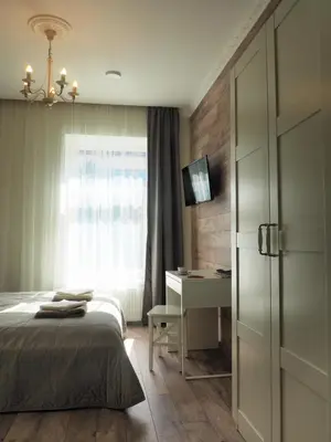 a bedroom with a bed and a desk and a window at Emi apartment in Vilnius