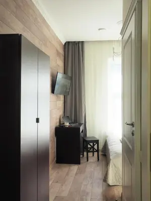 a bedroom with a bed and a desk with a laptop at Emi apartment in Vilnius