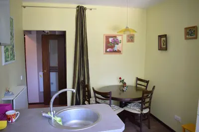 a kitchen with a table and a dining room at Butterfly Apartment in Visaginas
