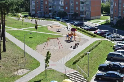 a park with a playground in a parking lot at Butterfly Apartment in Visaginas