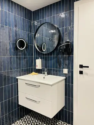 a bathroom with a white sink and a mirror at Duarto house, Sauna and Hot Tub in Šiaudinė