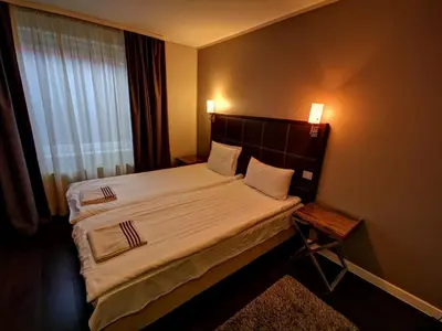 a bedroom with a large bed and a window at Duarto house, Sauna and Hot Tub in Šiaudinė