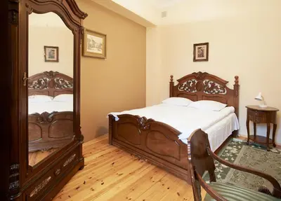 a bedroom with two beds and a large mirror at Cozy Apartment in Gothic style house in the Heart of the Old Town in Vilnius