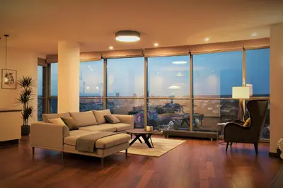 a living room with a couch and a large window at Luxury Panoramic Vilnius apartment in Vilnius