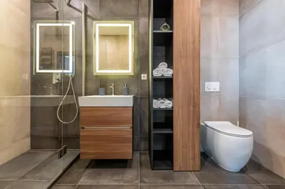 a bathroom with a toilet and a sink and a shower at Luxury Panoramic Vilnius apartment in Vilnius
