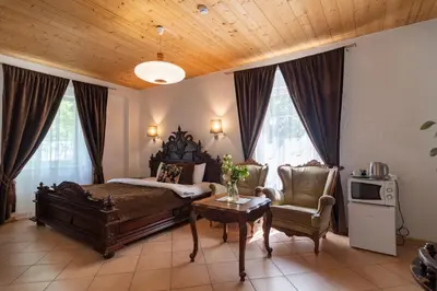 a bedroom with a bed and a table and a chair at Slėnis Trakuose in Trakai