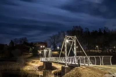 a white bridge over a river at night at Senoji užeiga in Molėtai