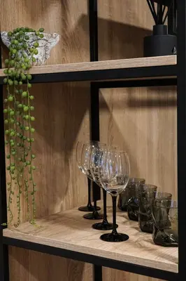 a row of wine glasses on a shelf at Senoji užeiga in Molėtai