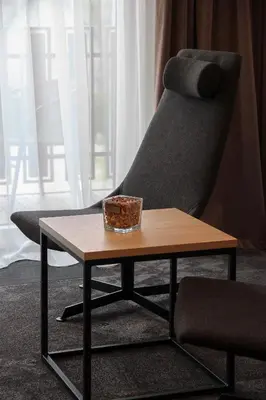 a chair and a table with a bowl on it at Senoji užeiga in Molėtai