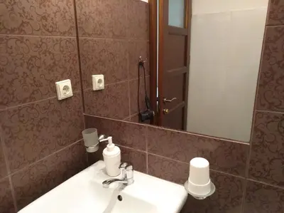 a bathroom with a sink and a mirror at Hostel Lux in Kaunas