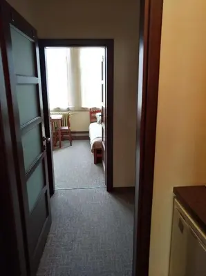a hallway with a door open to a room at Hostel Lux in Kaunas