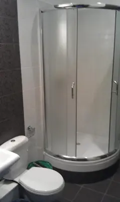 a bathroom with a shower with a toilet and a sink at Hostel Lux in Kaunas