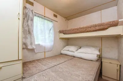 a small room with a bed and a window at Camping Mindunai in Mindūnai
