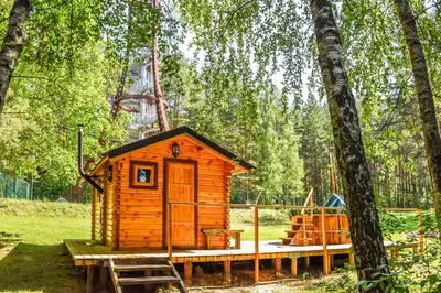 a small wooden cabin in the middle of a forest at Camping Mindunai in Mindūnai