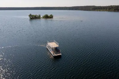 a small boat in the middle of a lake at Camping Mindunai in Mindūnai