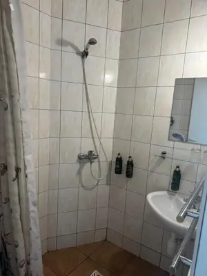a bathroom with a shower and a sink at Turnė Guest House in Šiauliai