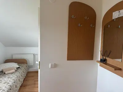 a room with a bed and some cabinets on the wall at Turnė Guest House in Šiauliai