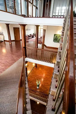 a spiral staircase in a building with a lobby at Hotel Violeta in Druskininkai