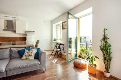 a living room with a couch and a large window at #inVilnius - Spacious & Bright 1BDR Apartment Shopping District in Vilnius