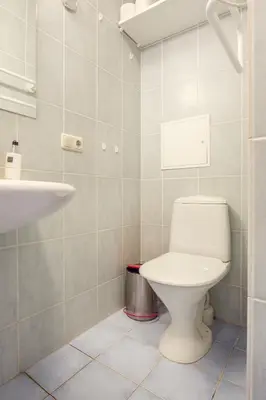 a bathroom with a toilet and a sink at #inVilnius - Spacious & Bright 1BDR Apartment Shopping District in Vilnius