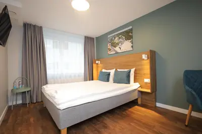 a bedroom with a large bed in a room at Stay Vilnius Hotel in Vilnius