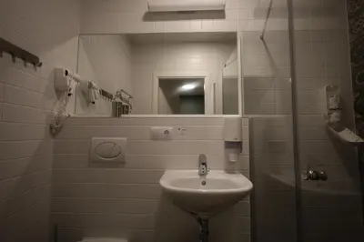 a bathroom with a sink and a mirror at Stay Vilnius Hotel in Vilnius