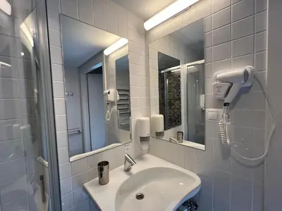 a bathroom with a sink and a mirror at Stay Vilnius Hotel in Vilnius