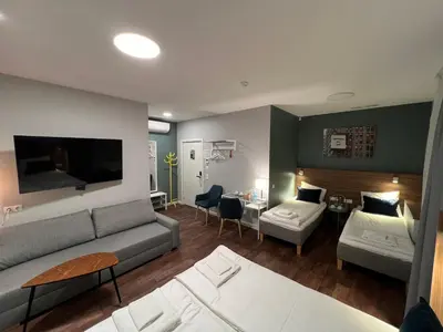 a living room with a couch and a table at Stay Vilnius Hotel in Vilnius