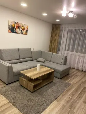 a living room with a couch and a coffee table at Apartments Victoria in Panevėžys