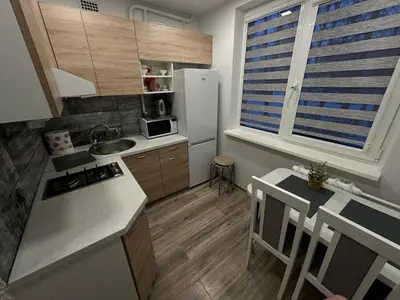a small kitchen with a sink and a refrigerator at Apartments Victoria in Panevėžys
