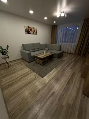 a living room with a couch and a coffee table at Apartments Victoria in Panevėžys