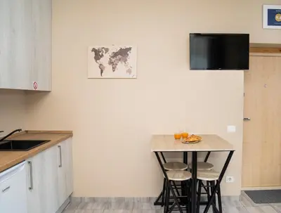 a kitchen with a small table with fruit on it at Cozy Stay Apartment in Kaunas