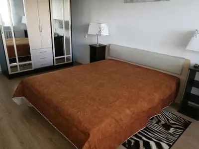 a bedroom with a large bed in a room at Tėjos guest house in Šiauliai