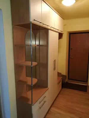 a closet with wooden shelves in a room at Tėjos guest house in Šiauliai