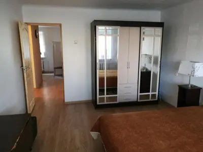 a room with a bed and a closet and a mirror at Tėjos guest house in Šiauliai