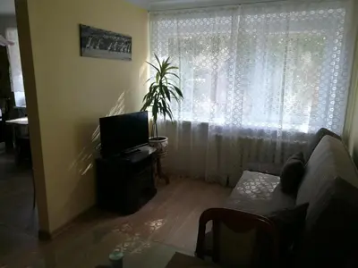 a living room with a couch and a window at Tėjos guest house in Šiauliai