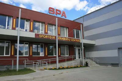 a red building with a sara sign on it at Ignalinos sporto ir pramogų centras in Ignalina