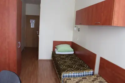 a room with a couch with a green pillow on it at Ignalinos sporto ir pramogų centras in Ignalina