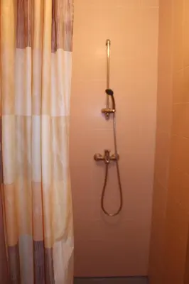a shower with a shower curtain in a bathroom at Ignalinos sporto ir pramogų centras in Ignalina