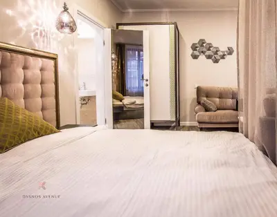 a bedroom with a white bed and a mirror at Dysnos Avenue Apartments in Vilnius