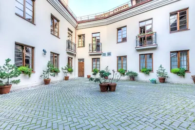 a courtyard of a building with potted plants at Dysnos Avenue Apartments in Vilnius