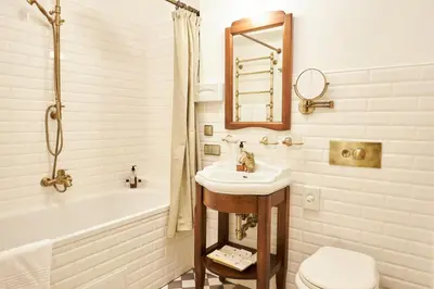 a bathroom with a sink and a tub and a toilet at Grand SPA Lietuva Serviced Apartments Dzūkija in Druskininkai