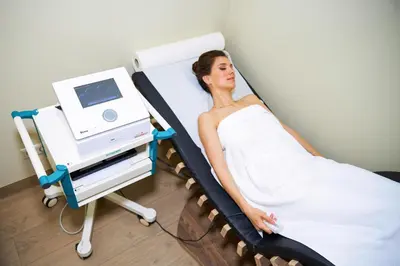 a woman laying in a hospital bed with a monitor at Grand SPA Lietuva Serviced Apartments Dzūkija in Druskininkai