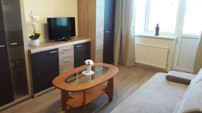 a living room with a coffee table and a television at Tulpių apartamentai in Panevėžys