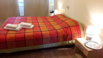 a bedroom with a bed with two towels on it at Tulpių apartamentai in Panevėžys